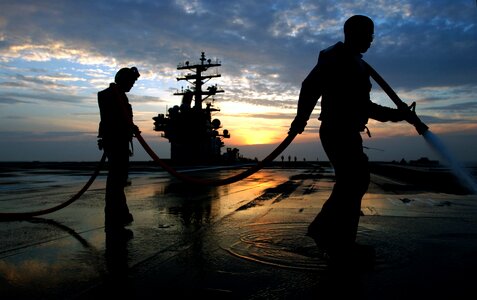 Aviation Boatswain's Mates wash down the ships flight deck photo