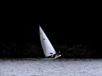 Sailing ship on the mountain lake photo