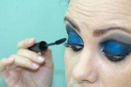 Makeup woman applying make up shadows photo