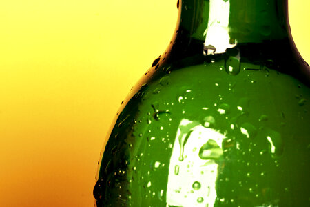 Bottle with water drops - Yellow Background photo
