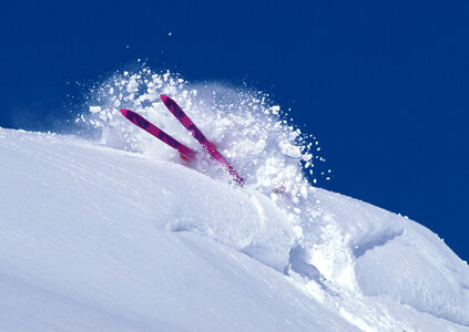 Skier tumbling through deep powder snow photo