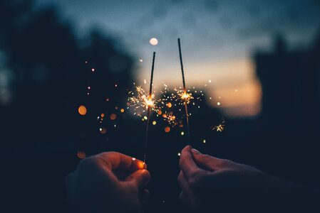 Hands lighting Sparkler Fireworks photo