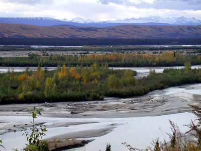 A braided river and snow-covered mountains photo
