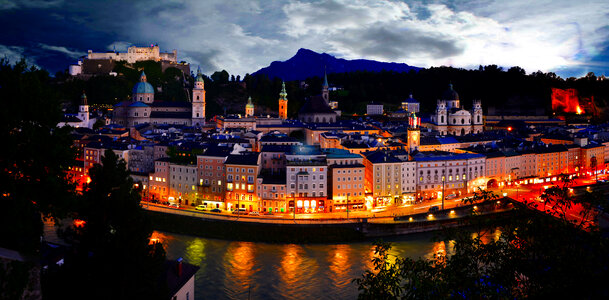 Riverfront lights and cityscape in Salzburg, Austria photo