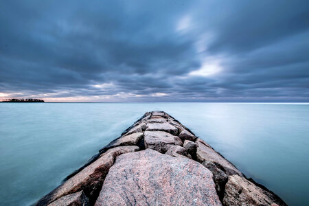 Storm clouds over the rocky walkway to the lake photo