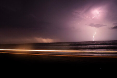 Dark Night with Lightning above Violet Sea photo