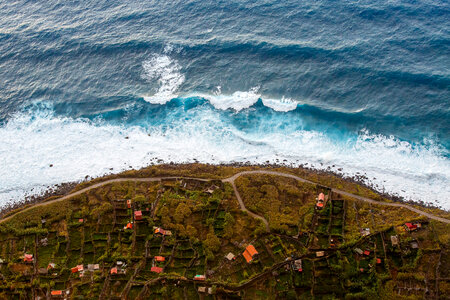 Waves from the sea crashing on the shoreline of a small town