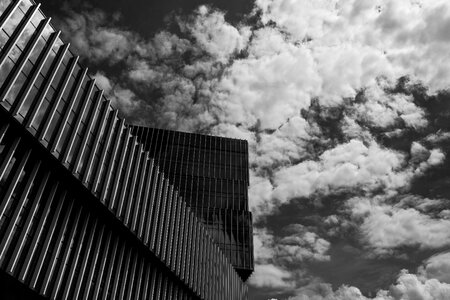 Modern Office Building with Facade of Glass against Sky with Clouds