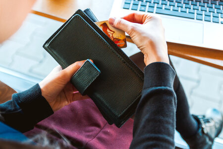 Woman with wallet is using her credit card for shopping online photo