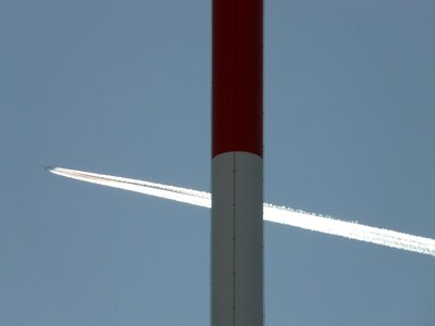 Transmission tower aircraft contrail photo