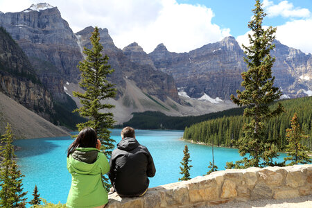 Couple looking at a Aquamarine Lake landscape in Banff National Park, Alberta, Canada photo