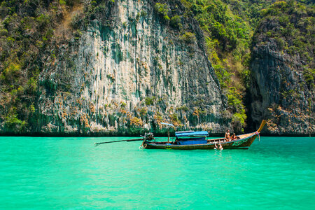 Brown & Blue Boat Near Cliff photo