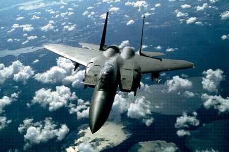 Jet Fighter flying above the clouds photo