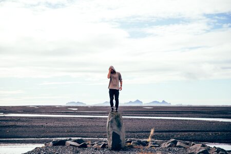 Man Standing On Tall Rock photo