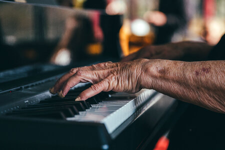 Hands of an Old Man Playing the Piano photo