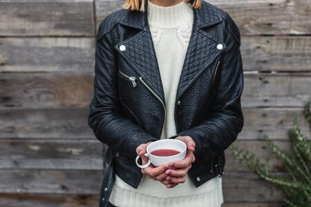 Woman holding a cup of coffee in her hands photo