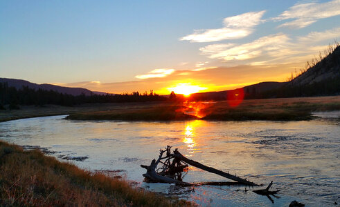 Sunset over the water and lake in Yellowstone National Park photo