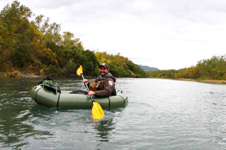 Service employee paddling a river raft photo