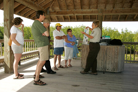 Employee assists refuge visitors photo