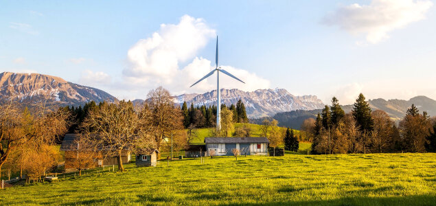 Wind Farm under the Mountains with meadow photo