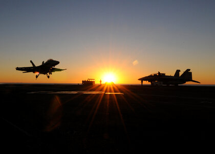 Fighter jets landing at sunset photo
