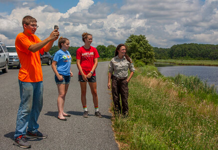 FWS staff with students taking cell phone pictures at wetland-4