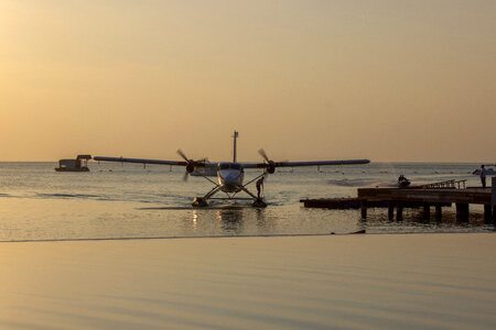 Sea Plane Landing at Tropical Beach Resort at Dawn photo
