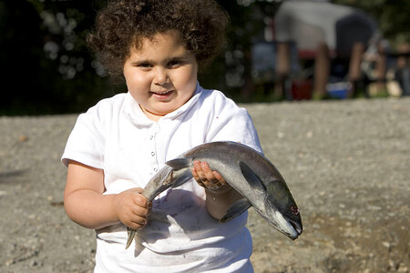 Small girl holding a fish photo