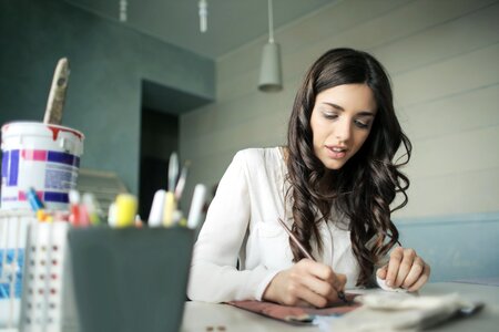 Young Woman Painting Desk photo