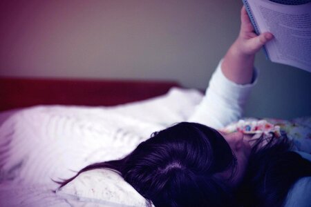 Woman Reading Book Bed photo