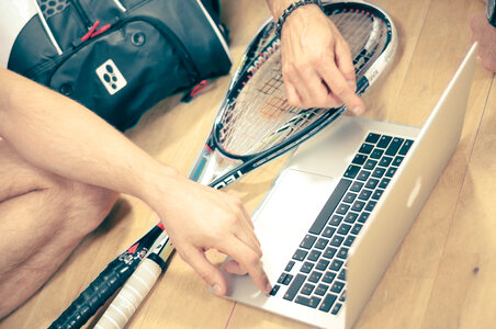 Raquetball player working on macbook pro