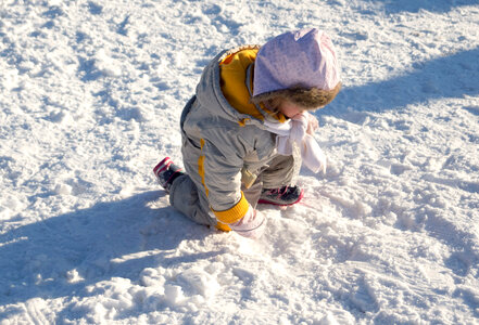 Child Playing on Snow photo