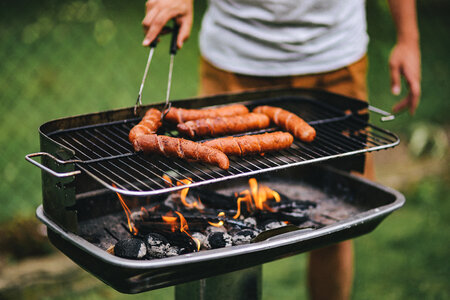 Man Grilling Sausages Outdoors photo