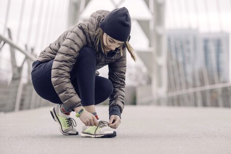 Female Athlete Tying Her Shoes photo