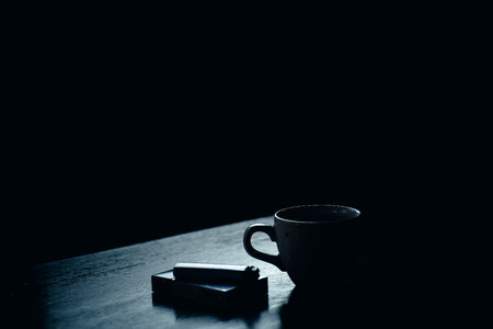 A Pack of Cigarettes and Coffee on the Table photo