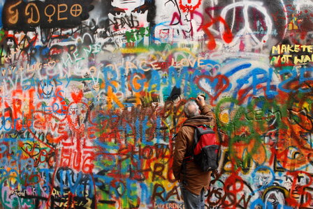 Guy painting on John Lennon wall photo