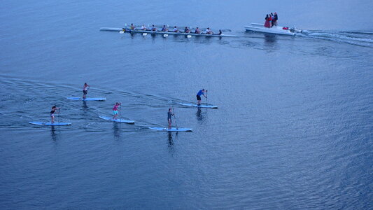 group of people stand up paddleboarding photo