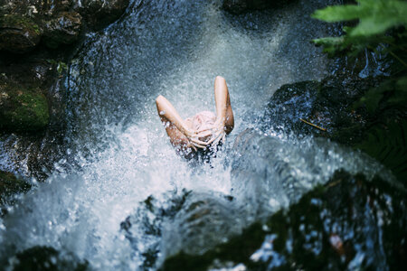 Woman Taking a Bath in the Waterfall photo