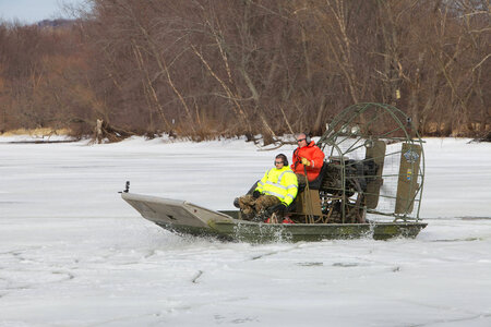 Employees riding on an airboat on the Mississippi River photo