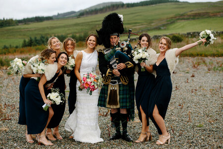 Beautiful Bride and Bridesmaids Posing with Bagpiper photo