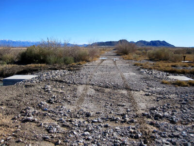Road damaged by debris due to flooding in the Ash Meadows National Wildlife Refuge photo