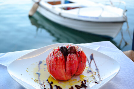 Tomato Salad by the Sea with Boat in the Background photo