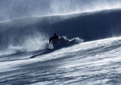 skier in deep powder on a steep slope photo