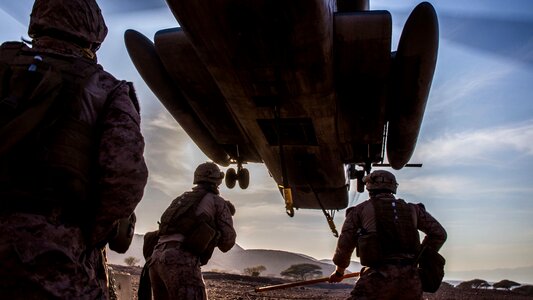 U.S. Marines prepare to attach a concrete barrier to a CH-53E photo