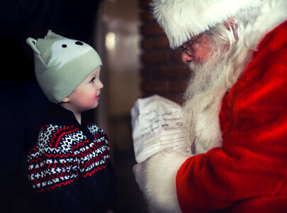 Santa talking with a young child photo