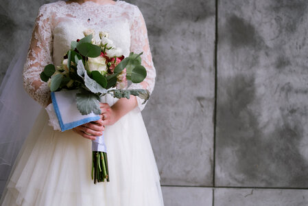 Bride in White Dress with Bouquet of Flowers photo