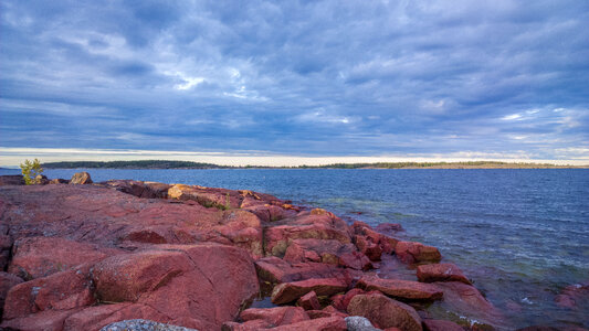 Seaside landscape with red rocks and sky photo