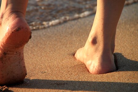 Legs sand sea photo