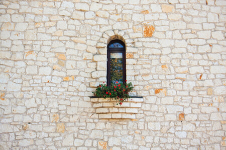 Stone Wall and Window with Red Geranium photo