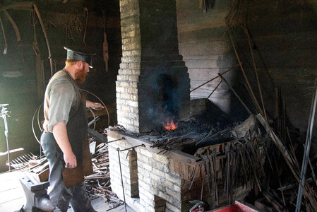 Blacksmith Heating Metal at Anvil
